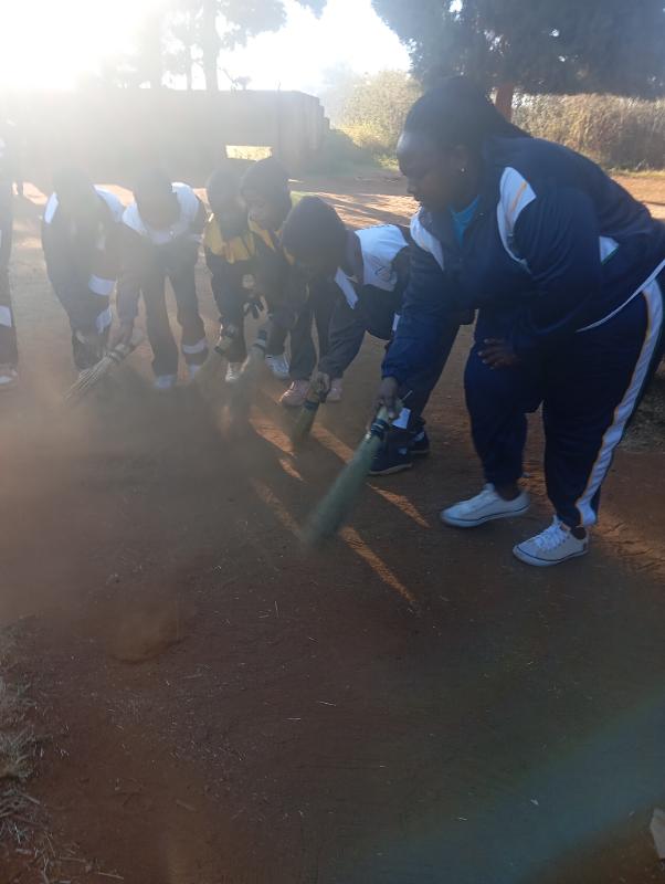 . cleaning up the school grounds.